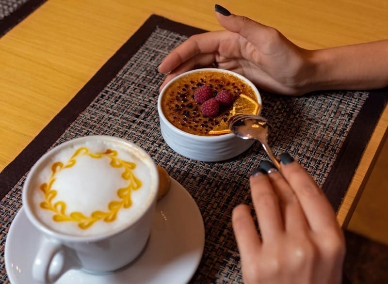 woman with pastry and latte