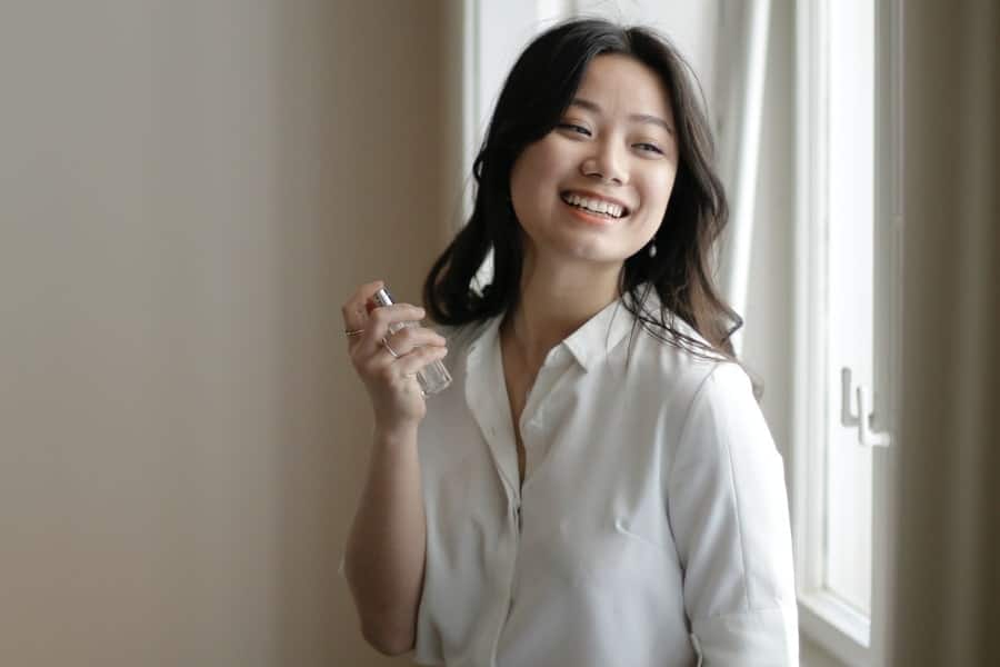 Woman applying perfume