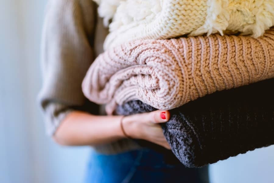 woman tidying blankets