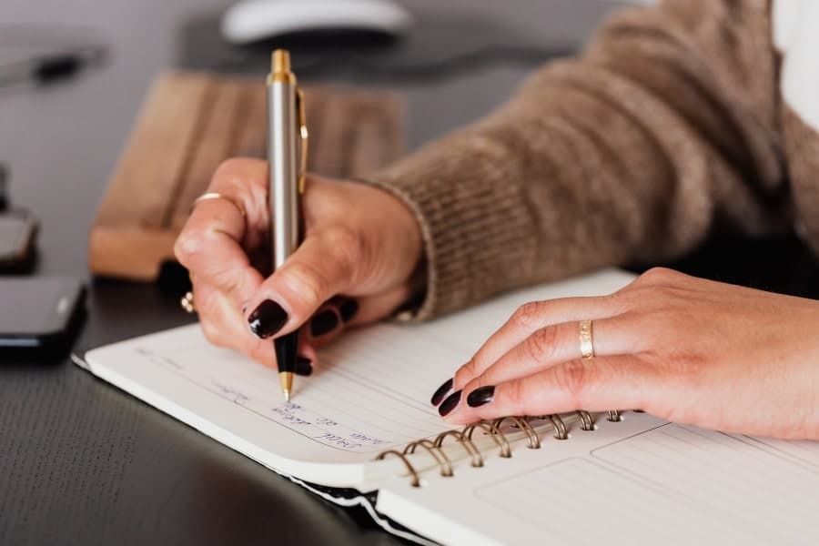 woman writing in notebook