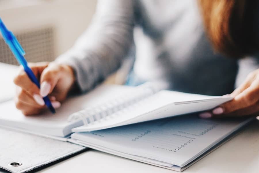 woman writing in planner