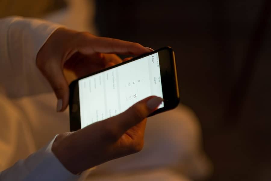 woman setting a bedtime alarm